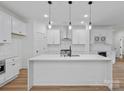 Beautiful kitchen with white cabinets, quartz countertops, pendant lighting, and stainless steel appliances at 8303 Adrian Ct, Charlotte, NC 28270