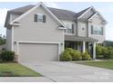 Attractive two-story home featuring a spacious driveway and manicured landscaping at 858 Oak Manor Se Dr, Concord, NC 28025