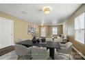 This is a virtually staged dining room featuring hardwood floors, neutral-colored walls, and a decorative chandelier at 8604 Rockmoor Ridge Rd, Charlotte, NC 28215