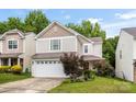 Charming two-story home featuring a white garage and tasteful landscaping at 9236 Clifton Meadow Dr, Matthews, NC 28105