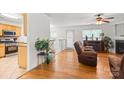 Open-concept living area features hardwood floors and fireplace, flowing to kitchen area at 9236 Clifton Meadow Dr, Matthews, NC 28105