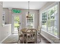 Bright breakfast nook with a round table, lots of windows, and a view of the backyard at 9412 Rosalyn Glen Rd, Cornelius, NC 28031