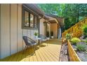 Inviting exterior view highlighting a comfortable seating area on the deck with views of the surrounding greenery at 10043 Tepa Pl, Tega Cay, SC 29708