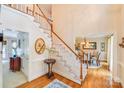 Bright foyer with staircase, hardwood floors, and view into dining room at 10127 Tallent Ln, Huntersville, NC 28078
