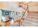 Open foyer featuring wood floors and staircase, with views into sitting room at 10127 Tallent Ln, Huntersville, NC 28078