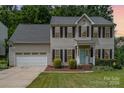 Charming two-story home with gray siding, black shutters, and an attached two-car garage at 108 Shade Tree Cir, Fort Mill, SC 29715
