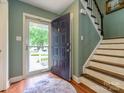 Welcoming foyer showcasing hardwood floors and an open staircase to the upper level at 11120 Sevilla Ct, Charlotte, NC 28226