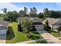A single-Gathering home featuring a stone facade, manicured lawn, and a convenient two-car garage at 112 E Neel Ranch Rd, Mooresville, NC 28115