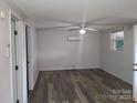 Open-concept living room featuring a modern ceiling fan, light grey walls and a window to let in natural light at 11550 Us Hwy 52 N Hwy, Ansonville, NC 28170