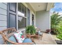 Inviting front porch with wicker seating, decorative cushions, and a charming outdoor ambiance at 11733 Mesquite Rd, Huntersville, NC 28078