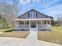 Lovely home featuring a cozy front porch, perfect for relaxing outdoors at 12300 Caldwell Rd, Charlotte, NC 28213