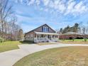 Inviting home with a covered porch and well-maintained lawn at 12300 Caldwell Rd, Charlotte, NC 28213
