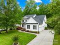 Charming two-story home with lush landscaping and a private driveway at 136 Pink Orchard Dr, Mooresville, NC 28115