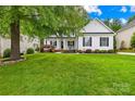 Attractive two-story home with a well-kept lawn and mature trees at 136 Pink Orchard Dr, Mooresville, NC 28115