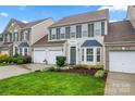 Daytime view of a two-story home with a two-car garage, landscaped front yard, and inviting curb appeal at 1418 Skidaway Nw St # 427, Concord, NC 28027