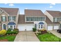 Aerial view of an attractive two-story home featuring a two-car garage and manicured lawns at 1418 Skidaway Nw St # 427, Concord, NC 28027