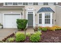 Inviting front entrance featuring a well-maintained lawn, lush landscaping, and a charming front door at 1418 Skidaway Nw St # 427, Concord, NC 28027