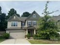 Charming two-story home with a two-car garage and well-maintained landscaping at 145 W Morehouse Ave, Mooresville, NC 28117