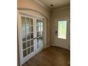 Bright foyer with double doors and hardwood flooring, leading to other rooms at 145 W Morehouse Ave, Mooresville, NC 28117
