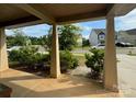 Inviting front porch with neutral-colored columns and a view of the neighborhood at 145 W Morehouse Ave, Mooresville, NC 28117