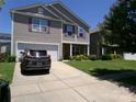 View of driveway leading to a two-story home with an attached garage at 1818 Windy Willow Ln, Dallas, NC 28034