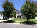 Charming two-story home with a well-maintained lawn and mature trees at 1818 Windy Willow Ln, Dallas, NC 28034