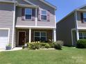 Inviting home featuring stone accents, a cozy porch, and vibrant landscaping at 1818 Windy Willow Ln, Dallas, NC 28034