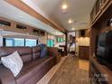 Inviting RV living room with a comfortable sofa, dining area, and a view into the kitchen at 207 Cardinal Dr, New London, NC 28127