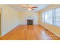 Bright, open living room featuring hardwood floors and a cozy fireplace at 208 S Thompson St, Monroe, NC 28112