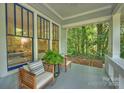 Close-up of a cozy front porch with seating, providing a relaxing outdoor space at 2223 Club Rd, Charlotte, NC 28205