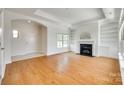 Spacious living room featuring hardwood floors, fireplace and a neutral color palette at 2261 Lincolnshire Ln, Waxhaw, NC 28173
