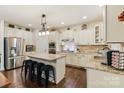 Bright kitchen featuring an island with seating, stainless steel appliances, and granite countertops at 274 Cove Creek Loop, Mooresville, NC 28117