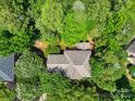 Aerial view of a home nestled among lush greenery, showcasing its tranquil and private setting at 3112 Planters Ridge Rd, Charlotte, NC 28270