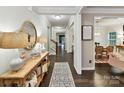 Bright foyer with dark hardwood floors, neutral walls, and decorative accents leading to living spaces at 3609 Benseval Ln, Matthews, NC 28105