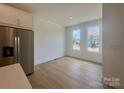Dining area with stainless steel refrigerator and bright windows, offering a modern living space at 3618 S Tryon St # 19, Charlotte, NC 28217