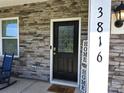 A front door with glass detail is set in a stone facade, and includes the house address at 3816 Rosewood Dr, Mount Holly, NC 28120