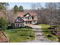 Spacious home with stone and siding, featuring a well-maintained lawn and a circular driveway at 394 Stonecliff Ln, Clover, SC 29710
