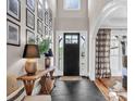 Inviting foyer with black slate floors and natural light filtering through the front door at 394 Stonecliff Ln, Clover, SC 29710