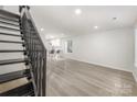 Open-concept space with staircase, kitchen access, light floors, and natural light enhancing the modern aesthetic at 3941 Briarhill Dr, Charlotte, NC 28215