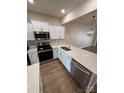 Modern kitchen featuring white cabinets, stainless steel appliances, and stylish fixtures at 4151 Town Center Rd, Harrisburg, NC 28075