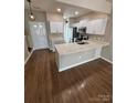 Bright kitchen boasts white cabinets, sleek countertops, modern stainless appliances, and stylish flooring at 4151 Town Center Rd, Harrisburg, NC 28075