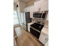 Contemporary kitchen featuring stainless steel appliances, white cabinets, and ample counter space at 4151 Town Center Rd, Harrisburg, NC 28075