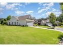 Exterior view of homes with green lawns, mature trees and driveway access to the community at 4208 Rosy Billed Ct # 30, Fort Mill, SC 29707