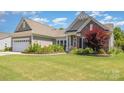 Charming single-story home with well-manicured lawn, flowerbeds, and attached two-car garage at 4208 Rosy Billed Ct # 30, Fort Mill, SC 29707