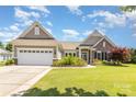 Charming single-story home with well-manicured lawn, flowerbeds, and attached two-car garage at 4208 Rosy Billed Ct # 30, Fort Mill, SC 29707