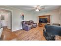 Cozy living room with hardwood floors, ceiling fan, and comfortable seating at 426 Valley St, Stanley, NC 28164