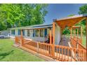 Inviting side porch with wood railing, covered seating area, and outdoor furniture at 426 Valley St, Stanley, NC 28164