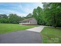 Charming home with lush landscaping, long driveway, and a welcoming covered front porch at 441 Vermilion Dr, York, SC 29745