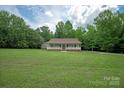 Traditional house with a covered front porch, brick foundation, white railing, and a green lawn at 441 Vermilion Dr, York, SC 29745
