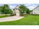 Charming two-story home with attached garage and well-manicured front lawn at 611 Sawtooth Oak Dr, Landis, NC 28088